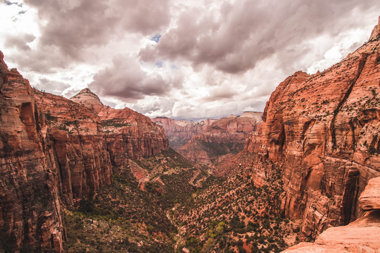 Crafting Captivating Headlines: Your awesome post title goes here Majestic view of Zion Canyon's red rock formations under dramatic skies in Utah.